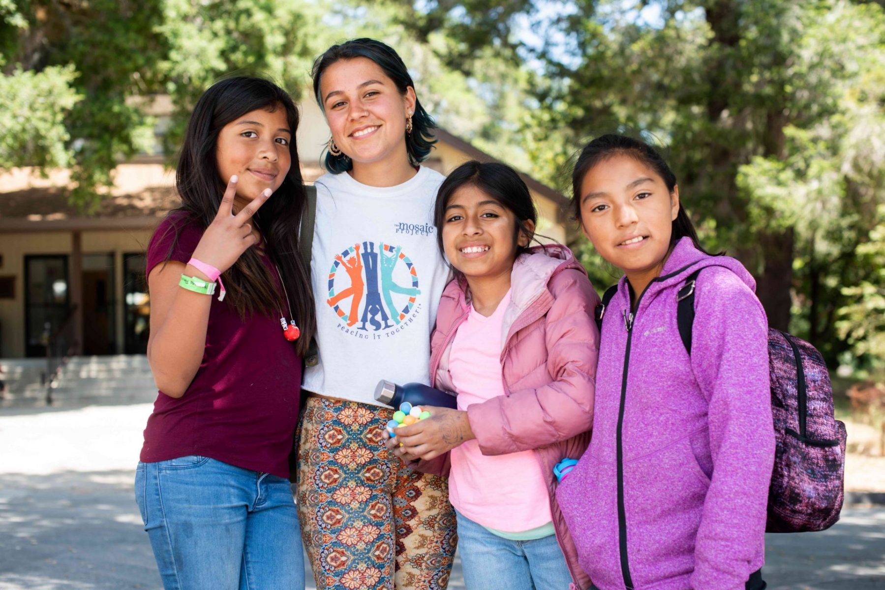 Three girls and Mosaic staff woman